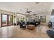 Large living room with an open floor plan, tile floors, fireplace, and access to the outdoor patio at 21205 E Excelsior Ave, Queen Creek, AZ 85142