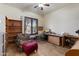 This home office space features built-in shelving, a desk area, and a comfortable chair at 21205 E Excelsior Ave, Queen Creek, AZ 85142