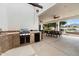 This outdoor kitchen features a built-in grill, a mini refrigerator, and ample counter space for outdoor dining at 21205 E Excelsior Ave, Queen Creek, AZ 85142