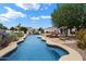 Backyard pool area with desert landscaping, mature trees, and lounge seating at 21205 E Excelsior Ave, Queen Creek, AZ 85142