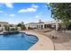 Backyard pool area with desert landscaping, mature trees, spa, and a fire pit at 21205 E Excelsior Ave, Queen Creek, AZ 85142
