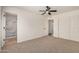 Bedroom featuring neutral carpet, a ceiling fan, large closet and a bathroom at 2124 E Boston St, Chandler, AZ 85225