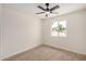 Bedroom featuring neutral carpet, a ceiling fan and a window overlooking the neighborhood at 2124 E Boston St, Chandler, AZ 85225