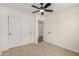 Bedroom featuring neutral carpet, a ceiling fan and a double door closet at 2124 E Boston St, Chandler, AZ 85225