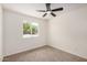 Bedroom featuring neutral carpet, a ceiling fan and a window at 2124 E Boston St, Chandler, AZ 85225