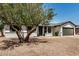 Charming single-story home featuring a desert landscape, a two-car garage, and a mature tree at 2124 E Boston St, Chandler, AZ 85225