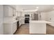 Beautiful kitchen with white cabinets, island, stainless steel appliances, and wood flooring at 2124 E Boston St, Chandler, AZ 85225