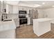 Modern kitchen featuring stainless steel appliances, white cabinets, and an island with seating at 2124 E Boston St, Chandler, AZ 85225