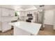 Bright, updated kitchen featuring stainless steel appliances, white cabinets, and a skylight for natural lighting at 2124 E Boston St, Chandler, AZ 85225