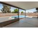 This covered patio overlooks a sparkling pool and low maintenance desert landscaping at 2124 E Boston St, Chandler, AZ 85225