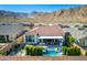 Stunning aerial view of backyard featuring a pool and outdoor seating area, all set with scenic mountain views in background at 21449 W Mariposa St, Buckeye, AZ 85396