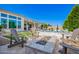 Inviting backyard features a sparkling pool, stylish stone fire pit, lounge chairs, and a covered patio for outdoor entertaining at 21449 W Mariposa St, Buckeye, AZ 85396