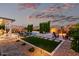 Luxurious backyard featuring a pool, spa, fire pit, and manicured landscaping at 21449 W Mariposa St, Buckeye, AZ 85396