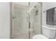 Modern bathroom featuring a walk-in shower with sleek glass doors and neutral-toned tiling at 21449 W Mariposa St, Buckeye, AZ 85396
