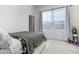 Well lit bedroom with gray comforter, large windows, and tiled floor at 21449 W Mariposa St, Buckeye, AZ 85396