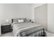 Neat bedroom with gray striped bedspread at 21449 W Mariposa St, Buckeye, AZ 85396