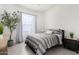 Bedroom with tiled floor and gray striped bedspread at 21449 W Mariposa St, Buckeye, AZ 85396