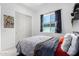 Spare bedroom with a bed and dark curtains at 21449 W Mariposa St, Buckeye, AZ 85396