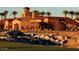 Picturesque clubhouse with stone bridge and waterfall feature with lush, green landscape at 21449 W Mariposa St, Buckeye, AZ 85396