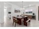 Modern dining room featuring an elegant chandelier, stylish furniture, and a wine refrigerator at 21449 W Mariposa St, Buckeye, AZ 85396