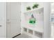 Charming entryway with a built-in bench, storage cubbies, and decorative potted plants at 21449 W Mariposa St, Buckeye, AZ 85396