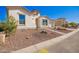Exterior view featuring desert landscaping, accent lighting, and an attached two-car garage at 21449 W Mariposa St, Buckeye, AZ 85396