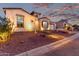 Inviting home exterior showcasing desert landscaping, walkway lighting, and attached garage at 21449 W Mariposa St, Buckeye, AZ 85396