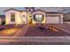 Charming exterior features a well-lit walkway, desert landscaping, and a two-car garage at 21449 W Mariposa St, Buckeye, AZ 85396