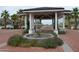 Community water feature with a fountain surrounded by flowers and a walkway at 21449 W Mariposa St, Buckeye, AZ 85396