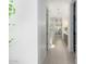 Bright hallway leading to the ensuite bathroom, with tile flooring and fresh white walls at 21449 W Mariposa St, Buckeye, AZ 85396