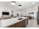 Open concept living and kitchen area with island seating, dining table and adjacent living room at 21449 W Mariposa St, Buckeye, AZ 85396