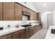 Well-appointed kitchen featuring stainless steel appliances, gas cooktop and quartz countertops at 21449 W Mariposa St, Buckeye, AZ 85396