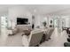 Spacious living room with tile flooring, modern furnishings, and a neutral color scheme at 21449 W Mariposa St, Buckeye, AZ 85396