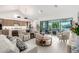 Open-concept living room with modern furnishings, tile floors, and access to the outdoor space at 21449 W Mariposa St, Buckeye, AZ 85396