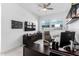 Spacious home office featuring a large desk area, sleek shelving, and bright natural light at 21449 W Mariposa St, Buckeye, AZ 85396