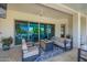 Inviting covered patio with comfortable seating and a modern fire pit, perfect for outdoor relaxation at 21449 W Mariposa St, Buckeye, AZ 85396