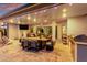 Spacious covered patio with a large dining table, ceiling fans, outdoor kitchen, and a view of the backyard at 21449 W Mariposa St, Buckeye, AZ 85396