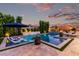 Backyard pool area with lounge chairs and lush landscaping, creating a serene and relaxing oasis at 21449 W Mariposa St, Buckeye, AZ 85396
