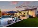 Backyard pool area with lounge chairs, dining and outdoor kitchen, ideal for outdoor gatherings and relaxation at 21449 W Mariposa St, Buckeye, AZ 85396