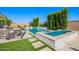 Beautifully landscaped backyard features a sparkling pool, spa, and cozy seating areas for relaxation at 21449 W Mariposa St, Buckeye, AZ 85396