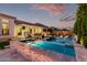 Stunning outdoor pool area featuring a covered patio, built-in grill, and lounge chairs, perfect for entertaining at 21449 W Mariposa St, Buckeye, AZ 85396