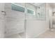 Bright tiled shower featuring glass door and window at 21449 W Mariposa St, Buckeye, AZ 85396