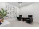 Bright sitting room with modern art, comfortable seating, and stylish light wood-look flooring at 21449 W Mariposa St, Buckeye, AZ 85396