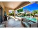 Charming covered patio features an outdoor kitchen and cozy seating area with views of the refreshing pool at 2156 W Periwinkle Way, Chandler, AZ 85248