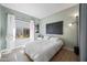Bright bedroom with lots of natural light, hardwood floors, and white linens at 2156 W Periwinkle Way, Chandler, AZ 85248
