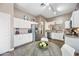 Bright eat-in kitchen featuring white cabinets, stainless steel appliances, and stylish countertops at 2156 W Periwinkle Way, Chandler, AZ 85248