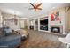 Living room with tile floors, ceiling fan, brick fireplace, and an open layout with recessed lighting at 2156 W Periwinkle Way, Chandler, AZ 85248