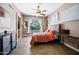 Comfortable main bedroom featuring a ceiling fan, natural light, and serene pool views at 2156 W Periwinkle Way, Chandler, AZ 85248
