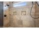 A shower with decorative tile, a shower head, and two built in shelves at 2156 W Periwinkle Way, Chandler, AZ 85248