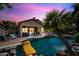 Scenic shot of pool with rock waterfall and slide, surrounded by lush landscaping for ultimate relaxation at 2156 W Periwinkle Way, Chandler, AZ 85248